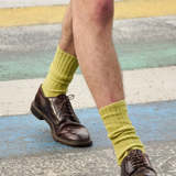 Man wearing black ribbed crew socks by Escuyer, made in Portugal