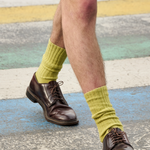 Man wearing golden orange ribbed crew socks by Escuyer, made in Portugal