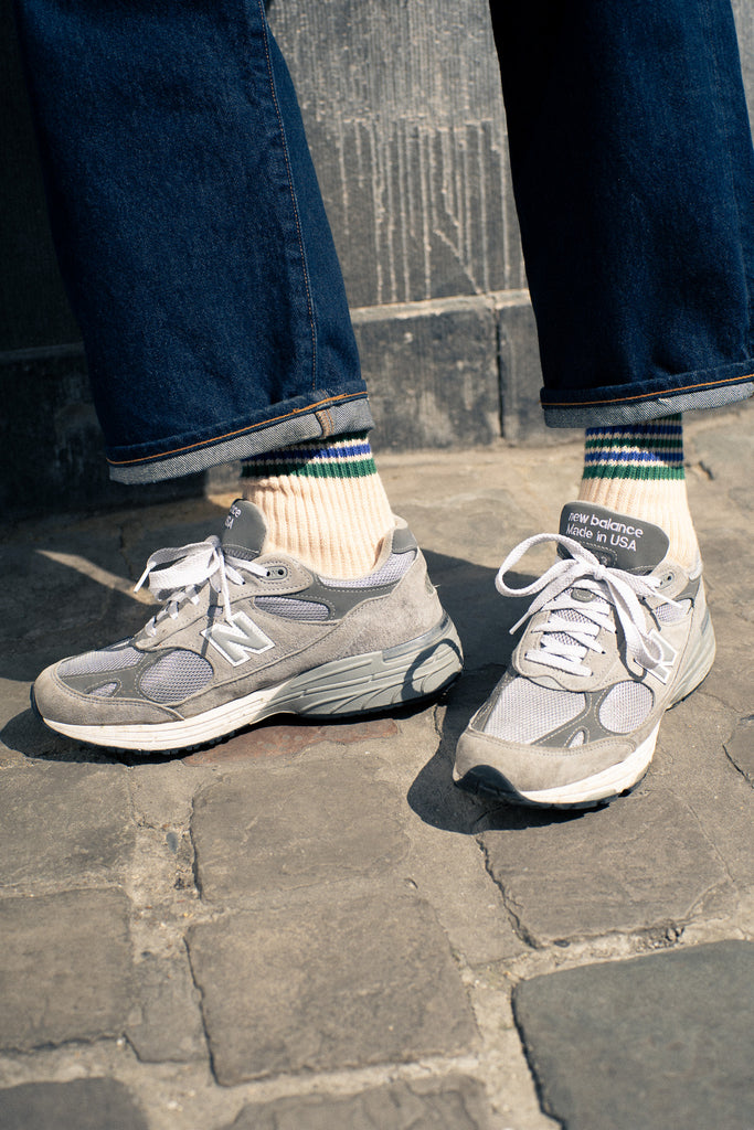 Man wearing 5 stripes socks with new balance sneakers