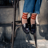 Woman wearing off black and green striped crew socks by Escuyer, made in Portugal