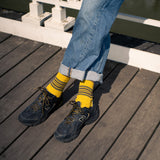 Escuyer Men's 5 Stripes Socks worn on a wooden deck — vintage athletics-inspired, knitted in Portugal