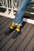 Man wearing yellow stripes socks with new balance sneakers