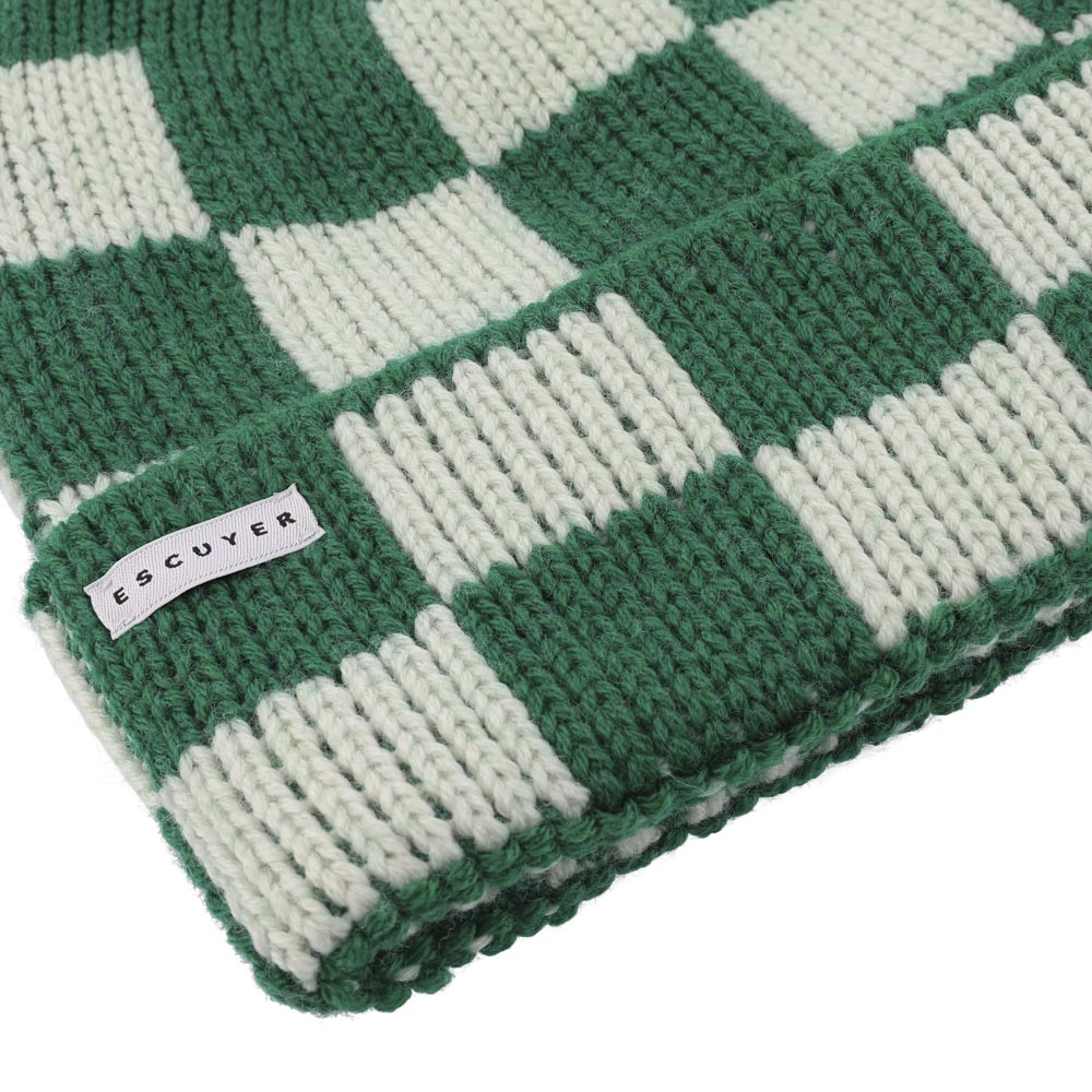 Side view of green and cream checkered knit merino beanie