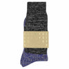A pair of melange block socks in black and bright blue colors, crafted from cotton blend yarns and made in Portugal