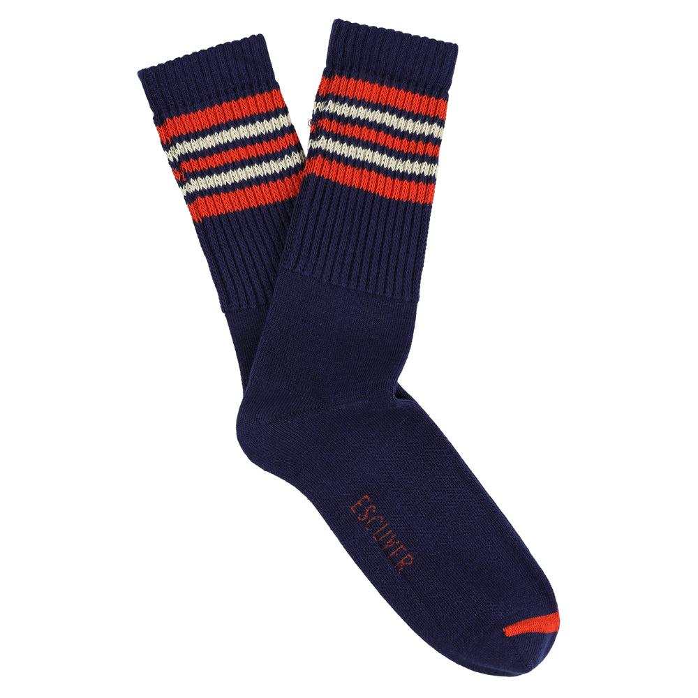 A pair of blue socks with orange and ecru stripes on the cuff.