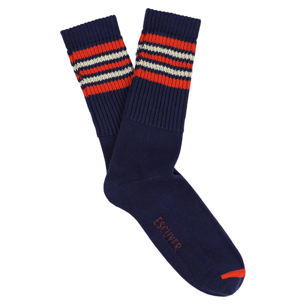 A pair of blue socks with orange and ecru stripes on the cuff.
