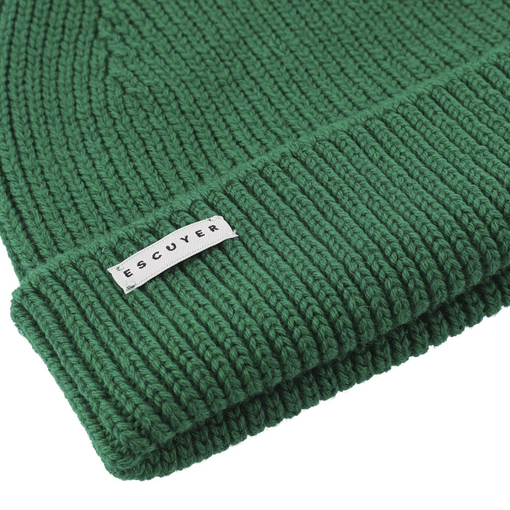 Side view of bold green ribbed merino wool beanie with folded cuff