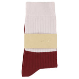 Pair of socks with a beige band displaying a logo on a white background