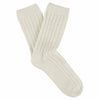 A pair of ecru-colored cashmere crew socks with a ribbed design, lying flat against a solid background.