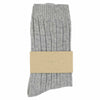 A pair of light grey ribbed cashmere crew socks with a beige band that has 'ESCUYER' written on it.