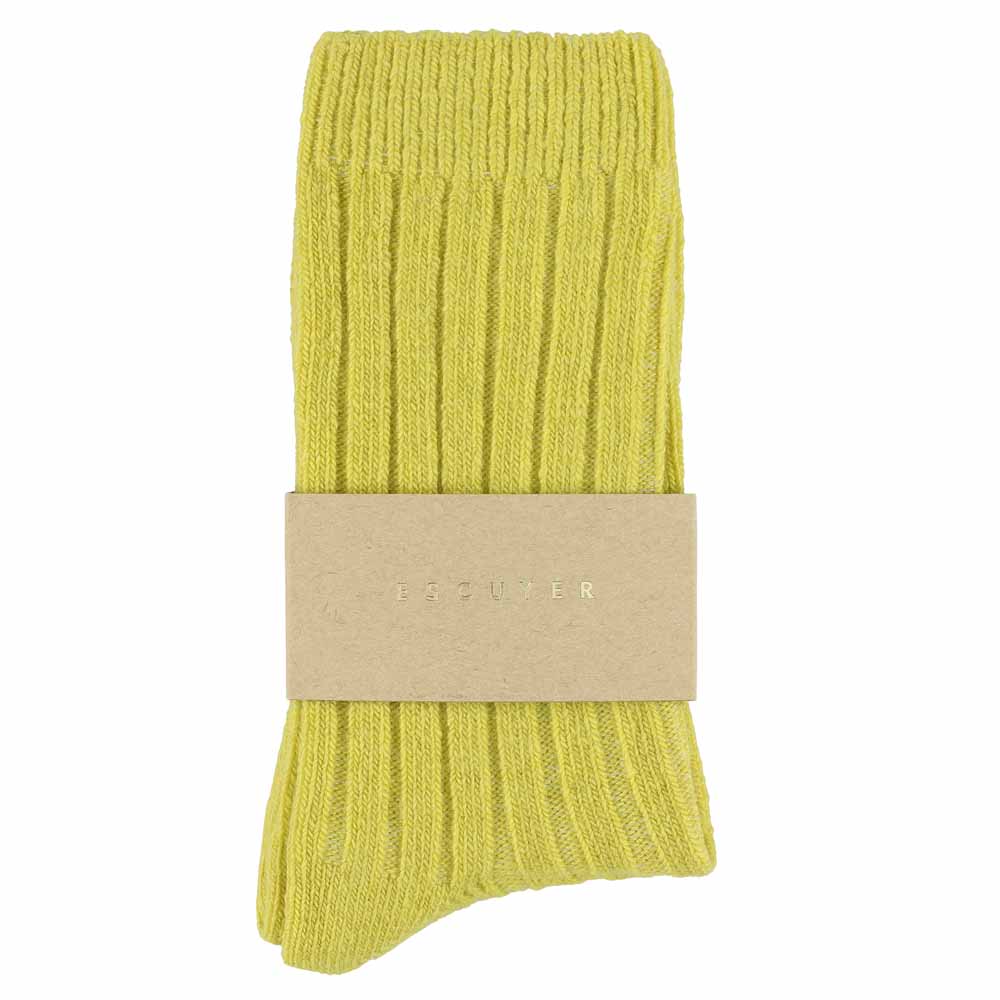 A pair of yellow cashmere crew socks with a brand tag attached to the ankle.