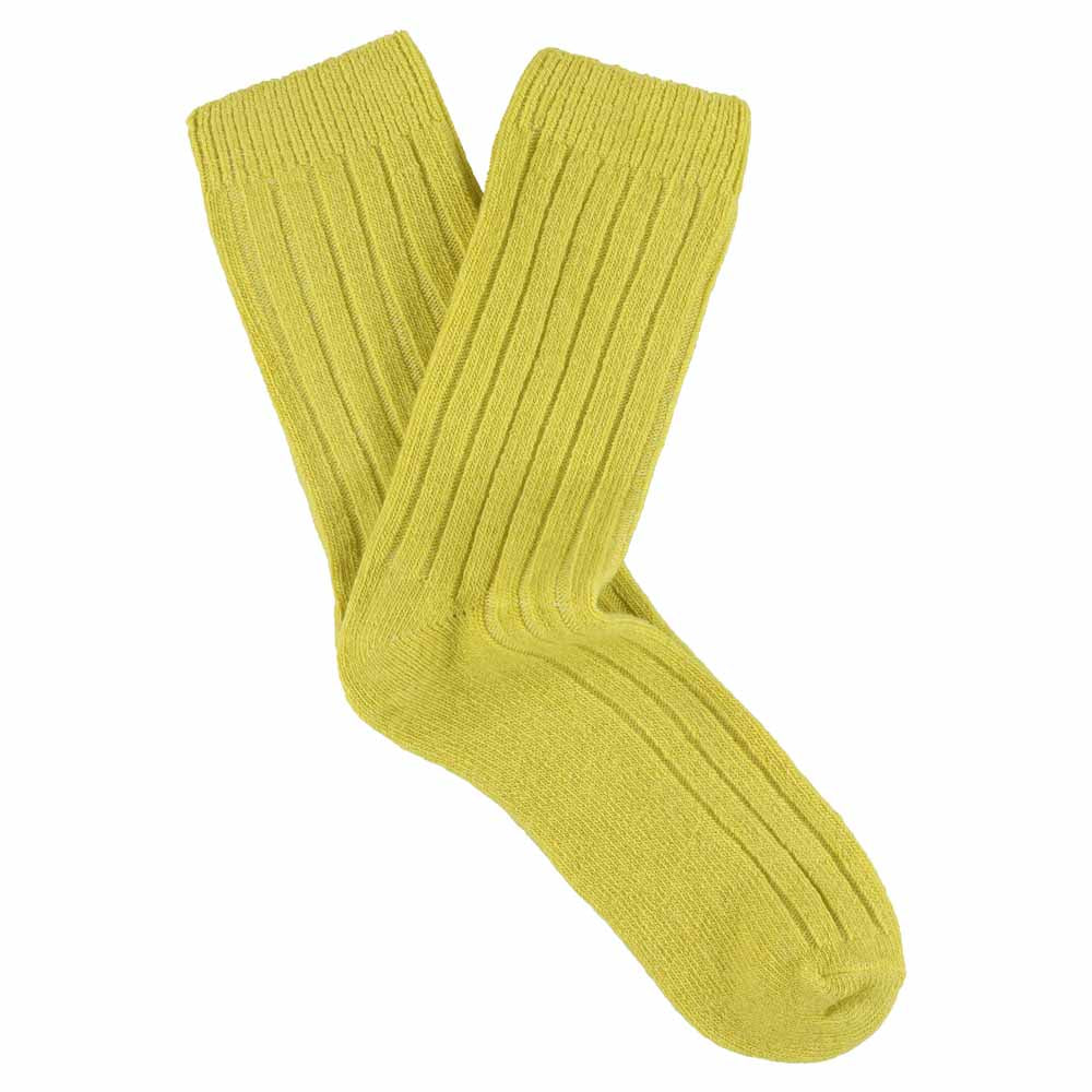A pair of yellow cashmere crew socks for women, showing a ribbed texture and heel counter.