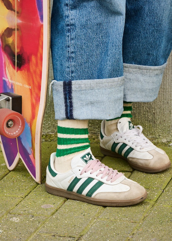 People wearing a striped "Ecru / Green" socks from Escuyer brand