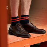 Man wearing Escuyer Men Striped Ankle Socks Orange / Ecru with brown loafers — vibrant summer style