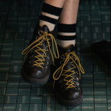 Person wearing black socks with ecru stripes made of wool and cashmere (made in Portugal)