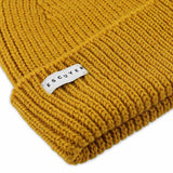 Side view of mustard ribbed merino wool beanie with folded cuff