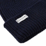 Side view of navy ribbed merino wool beanie with folded cuff