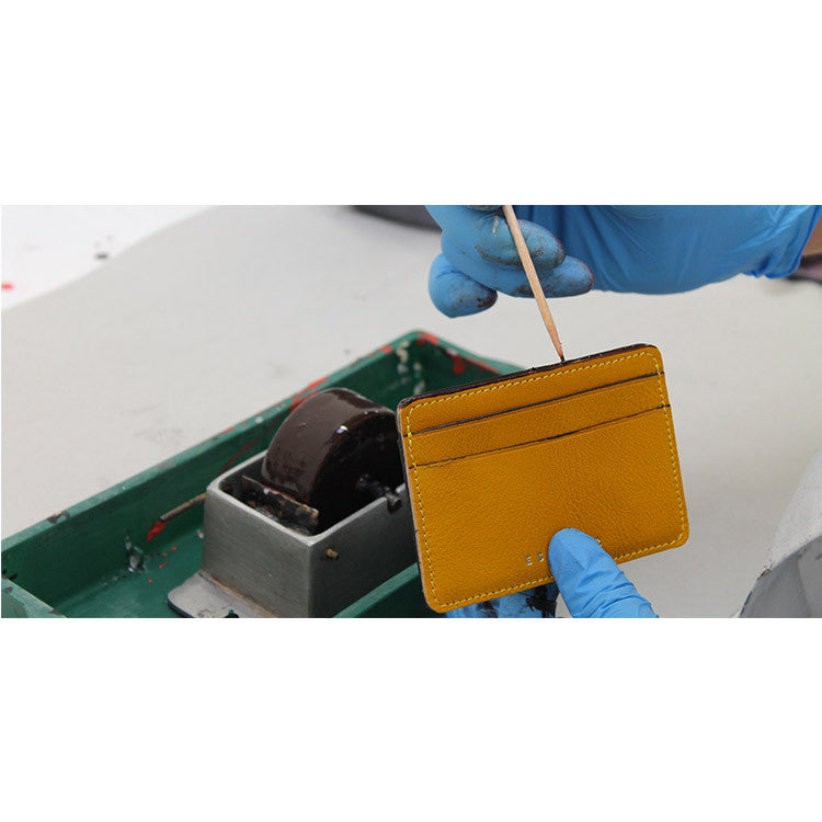 Escuyer yellow leather cardholder showing patina and texture of vegetable tanned leather